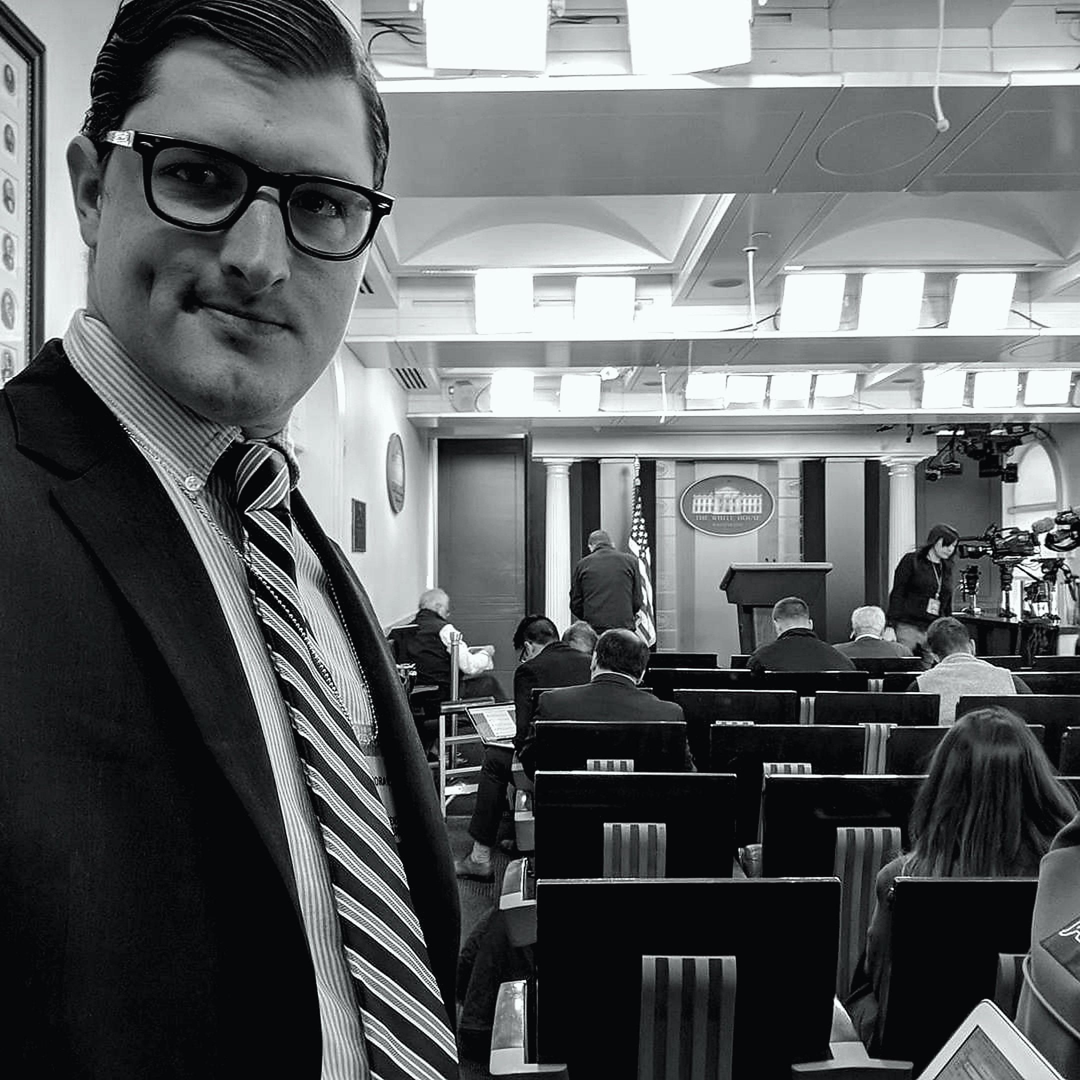 Nick Fouriezos in an editorial portrait from a press briefing environment